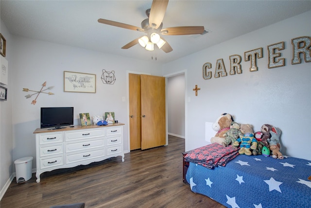 bedroom with ceiling fan and dark hardwood / wood-style flooring