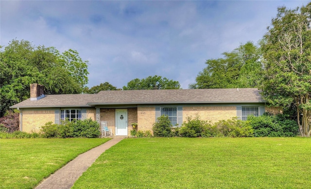 ranch-style home featuring a front yard