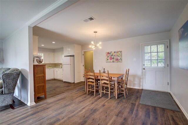 dining space featuring a chandelier and dark hardwood / wood-style floors