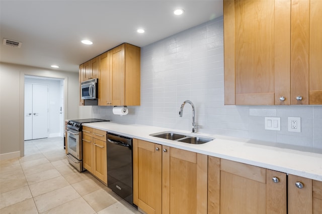 kitchen featuring decorative backsplash, light tile patterned flooring, sink, and appliances with stainless steel finishes