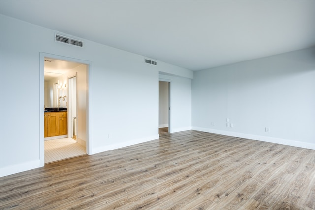 spare room with light hardwood / wood-style flooring