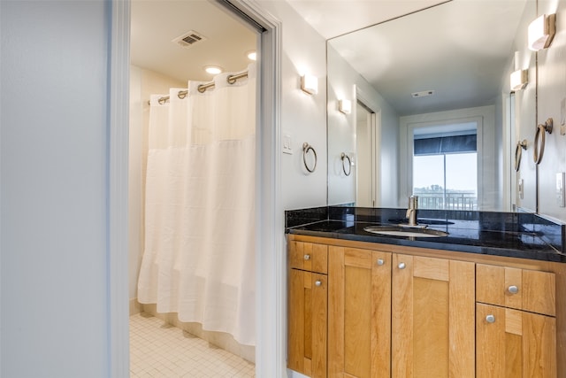 bathroom with tile patterned flooring and vanity