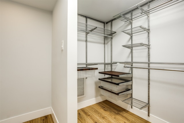 spacious closet featuring hardwood / wood-style flooring