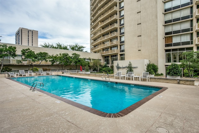 view of swimming pool with a patio area