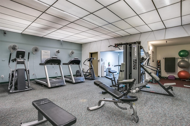 exercise room featuring a paneled ceiling