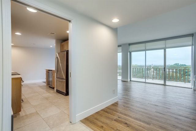 hallway featuring light hardwood / wood-style flooring and a wall of windows