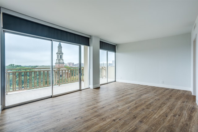 unfurnished room featuring hardwood / wood-style flooring