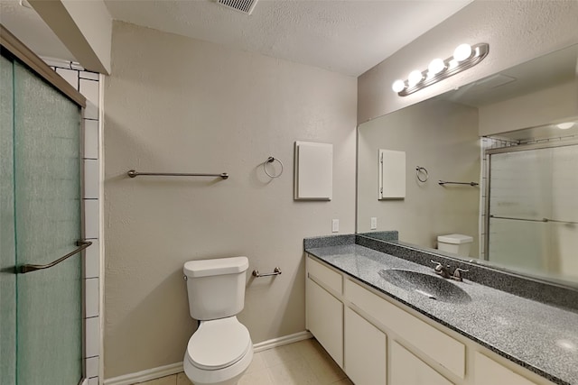 bathroom featuring walk in shower, tile patterned floors, vanity, and toilet