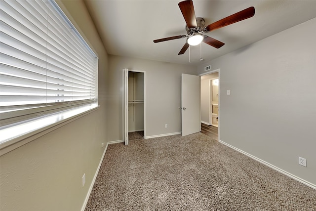 unfurnished bedroom with carpet, ceiling fan, and a closet