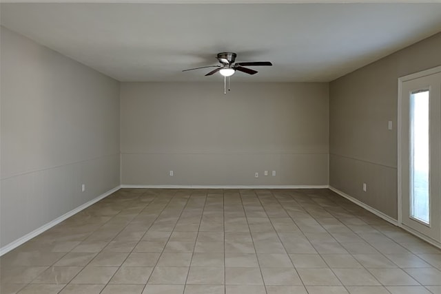 spare room with ceiling fan and light tile patterned floors