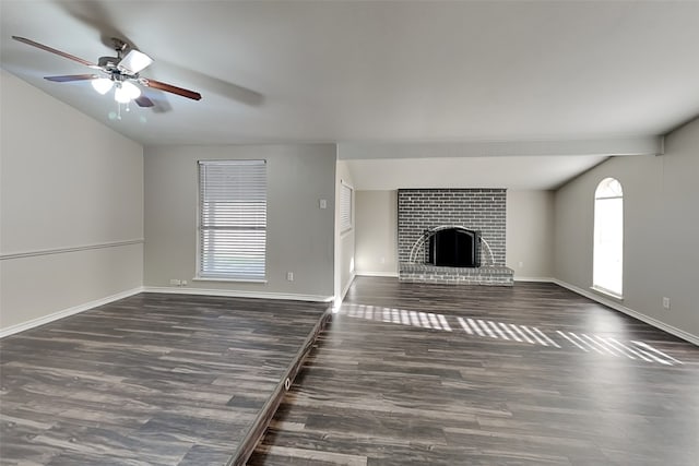 unfurnished living room with a fireplace, dark hardwood / wood-style floors, vaulted ceiling, and ceiling fan