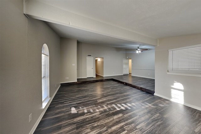 unfurnished room featuring dark hardwood / wood-style floors and ceiling fan