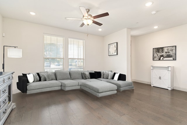 living room with ceiling fan and dark hardwood / wood-style flooring