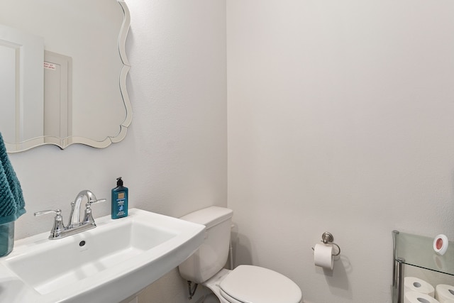 bathroom featuring toilet and sink