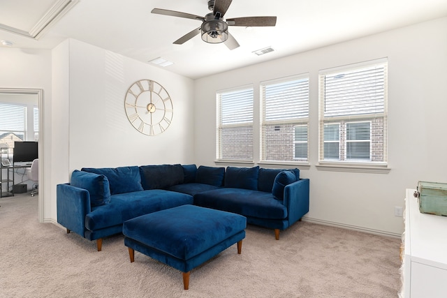 carpeted living room featuring a wealth of natural light and ceiling fan