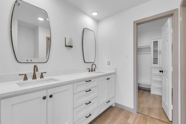 bathroom with vanity and hardwood / wood-style flooring