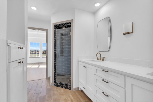 bathroom featuring vanity, hardwood / wood-style floors, and walk in shower