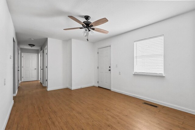 unfurnished room featuring ceiling fan and light hardwood / wood-style floors