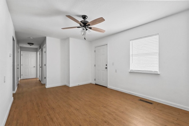 unfurnished room featuring hardwood / wood-style flooring and ceiling fan