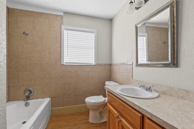 full bathroom with a wealth of natural light, vanity, wood-type flooring, and toilet