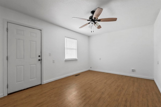 entryway with ceiling fan, a textured ceiling, and hardwood / wood-style flooring