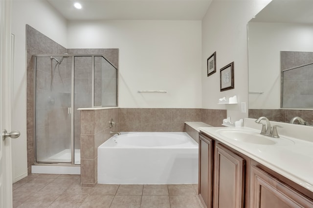 bathroom with tile patterned flooring, vanity, and plus walk in shower