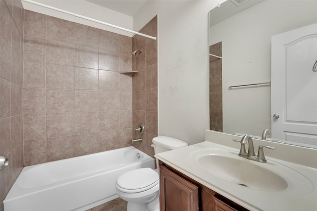 full bathroom featuring vanity, toilet, and tiled shower / bath