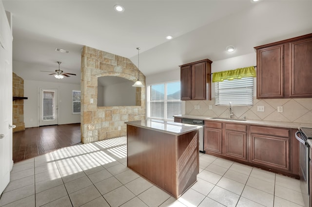 kitchen with sink, a center island, pendant lighting, light hardwood / wood-style floors, and appliances with stainless steel finishes