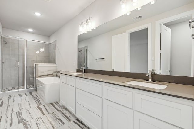 bathroom featuring vanity and shower with separate bathtub