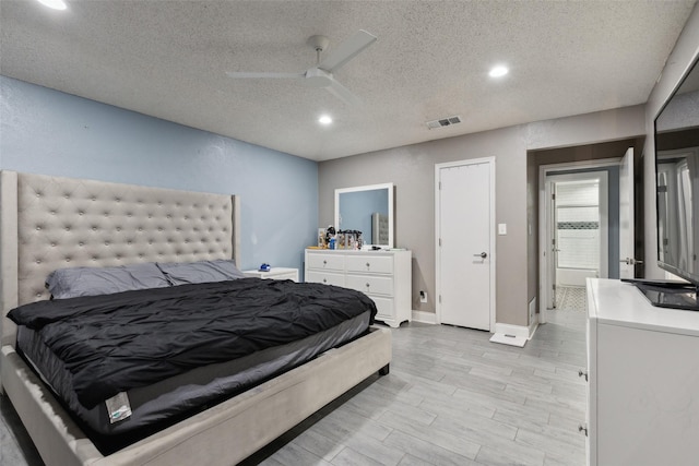 bedroom with a textured ceiling, light hardwood / wood-style flooring, and ceiling fan