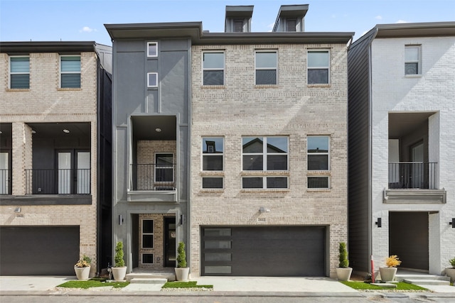 multi unit property featuring brick siding and an attached garage