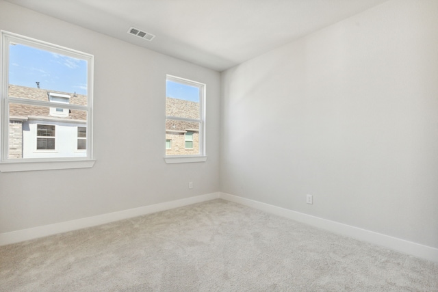 unfurnished room with light colored carpet