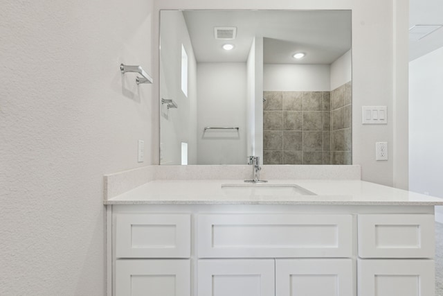 bathroom featuring vanity and a shower