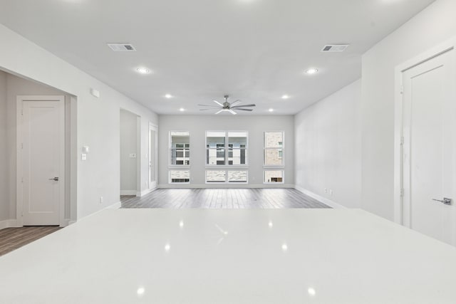 2543 Carolwood Ln, Dallas, TX 75212 - unfurnished living room with wood finished floors, baseboards, ceiling fan, and recessed lighting