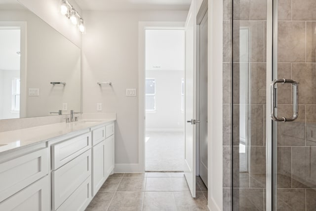 bathroom featuring vanity, an enclosed shower, and tile patterned floors