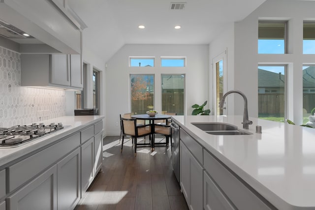 kitchen featuring gray cabinetry, sink, stainless steel appliances, dark wood-type flooring, and backsplash