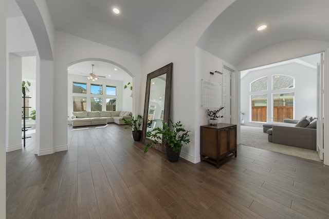 hallway featuring dark hardwood / wood-style flooring and vaulted ceiling