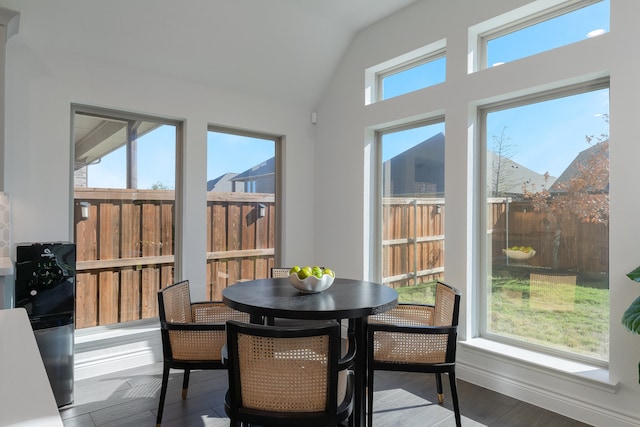 sunroom / solarium featuring a mountain view, vaulted ceiling, and plenty of natural light