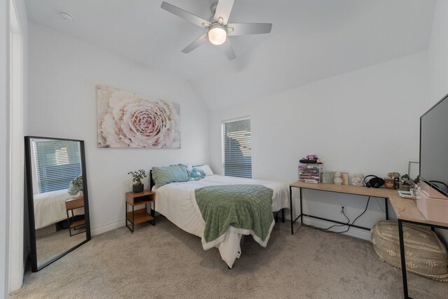 bedroom with ceiling fan, light carpet, and vaulted ceiling