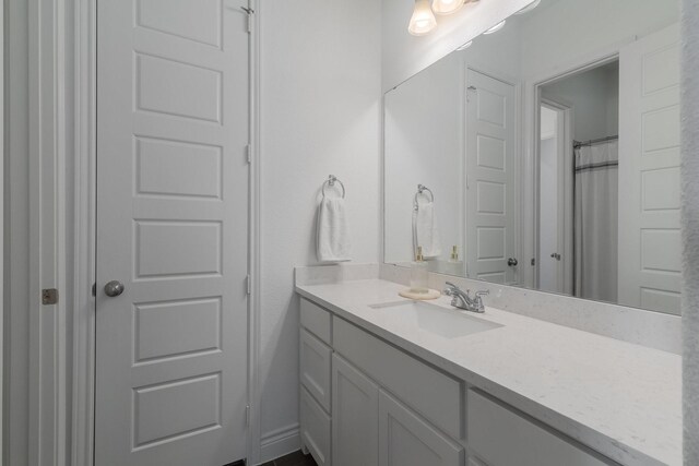 bathroom featuring a shower with curtain and vanity