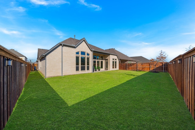 rear view of property featuring a yard