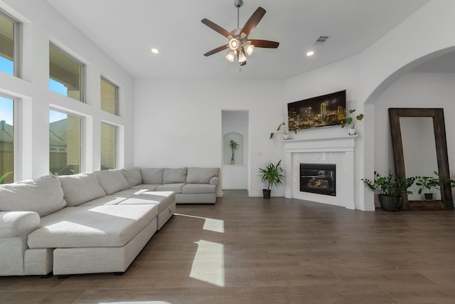 living room with ceiling fan and dark wood-type flooring