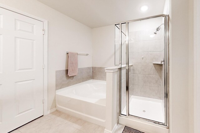 full bath featuring a shower stall and a bath