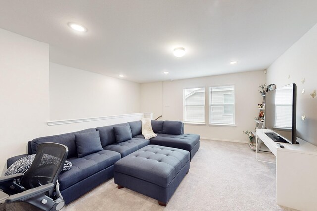 living area with recessed lighting, baseboards, and light colored carpet