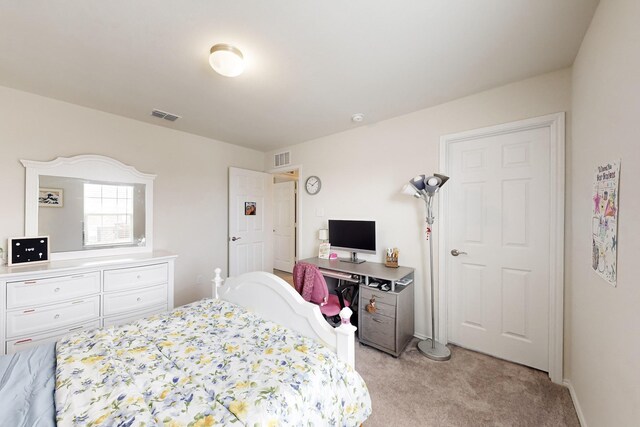 bedroom with baseboards, visible vents, and light colored carpet