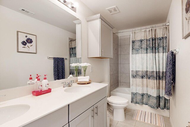 bathroom with shower / tub combo, tile patterned flooring, visible vents, and a sink