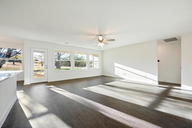 unfurnished living room featuring dark hardwood / wood-style floors and ceiling fan