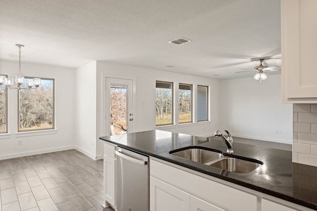 kitchen featuring white cabinetry, stainless steel dishwasher, plenty of natural light, and sink