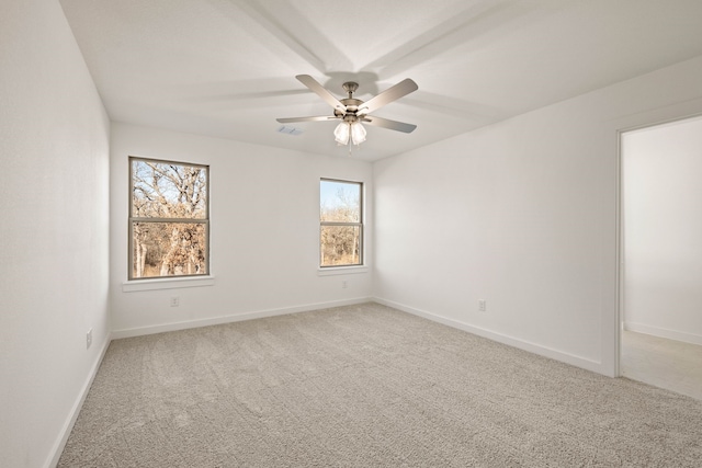 spare room with carpet floors and ceiling fan