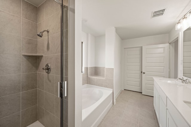 bathroom featuring vanity, separate shower and tub, and tile patterned floors